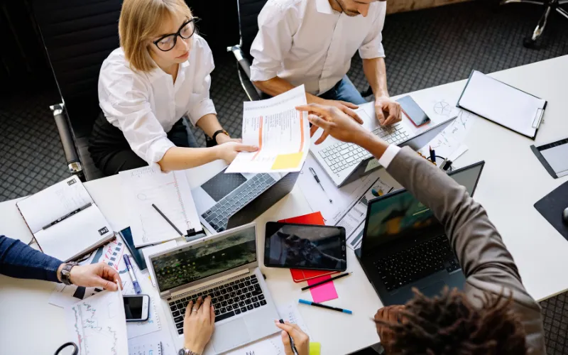 Small team reviewing an ecommerce site build on a shared screen